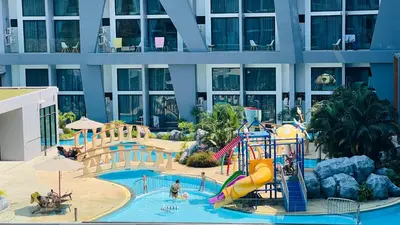 a large building with a water park with a slide at Loft condo in Phuket