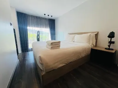 a bedroom with a bed with towels on it at Loft condo in Phuket