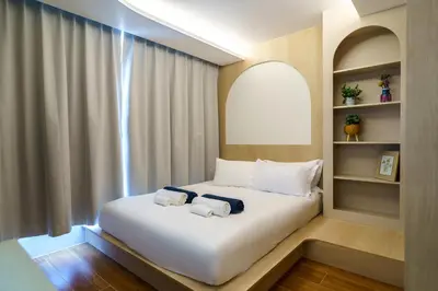 a bedroom with a large white bed with a window at Super 1Bdr Fantasea, Kamala Beach Roof Pol Wi Fi in Kamala Beach