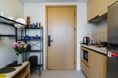 a kitchen with a door leading into a kitchen at Super 1Bdr Fantasea, Kamala Beach Roof Pol Wi Fi in Kamala Beach