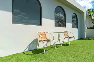 two chairs and a table on a lawn at Super 1Bdr Fantasea, Kamala Beach Roof Pol Wi Fi in Kamala Beach