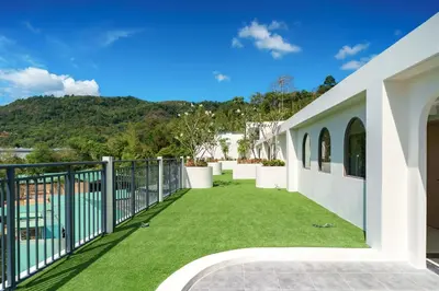 a view from the balcony of a house with green grass at Super 1Bdr Fantasea, Kamala Beach Roof Pol Wi Fi in Kamala Beach