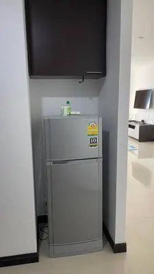 a small refrigerator in a room with a wall at Sea view studio Chic Condo Karon in Karon Beach