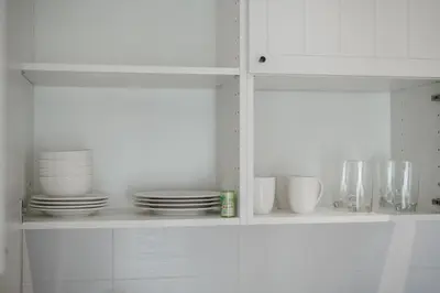 a white cabinet with plates and dishes on it at Квартира в The Title Halo 1 in Nai Yang Beach