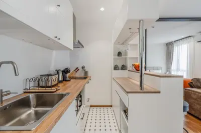 a kitchen with white cabinets and a sink at Квартира в The Title Halo 1 in Nai Yang Beach