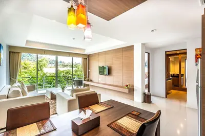 a living room with a couch and a table at Bangtao Tropical Residence Resort and Spa in Surin Beach