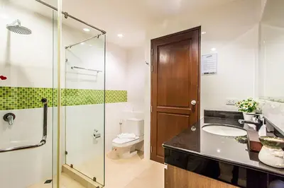 a bathroom with a shower and a sink and a toilet at Bangtao Tropical Residence Resort and Spa in Surin Beach
