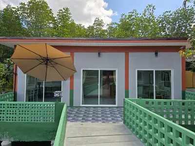 a small building with an umbrella in front of it at Aonang Riverside Home in Ban Khlong Son