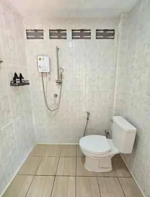a bathroom with a toilet and a shower at Aonang Riverside Home in Ban Khlong Son