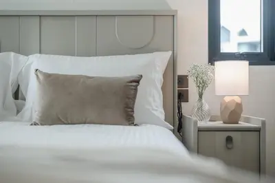 a white bedroom with a white bed and a lamp at Квартира в The Title Halo 1 in Nai Yang Beach