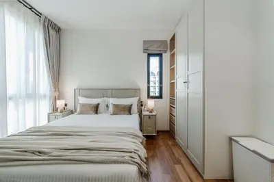 a white bedroom with a large bed and a window at Квартира в The Title Halo 1 in Nai Yang Beach