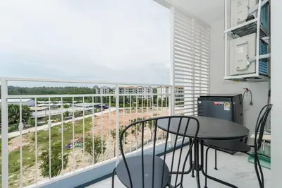 a balcony with a table and chairs and a view at Квартира в The Title Halo 1 in Nai Yang Beach