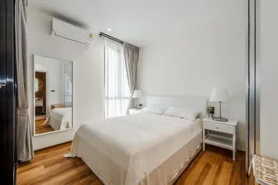 a white bedroom with a bed and a mirror at Квартира в The Title Halo 1 in Nai Yang Beach