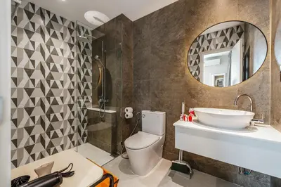 a bathroom with a toilet and a sink and a mirror at Квартира в The Title Halo 1 in Nai Yang Beach