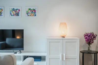 a living room with a couch and a table with a lamp at Квартира в The Title Halo 1 in Nai Yang Beach