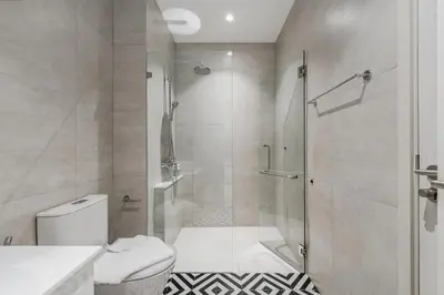 a white bathroom with a shower and a toilet at Квартира в The Title Halo 1 in Nai Yang Beach
