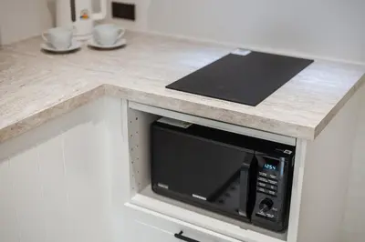 a counter top with a microwave in a kitchen at Квартира в The Title Halo 1 in Nai Yang Beach
