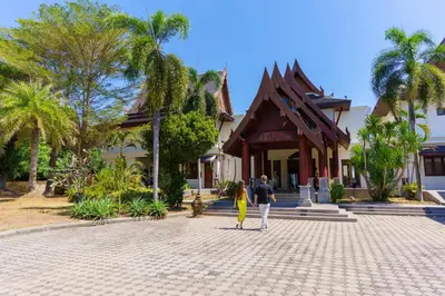 a man and a woman standing in front of a building at Grand View Panwa Luxury Villa in Ban Ao Makham