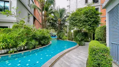 a swimming pool in the middle of a building at Digital Nomad Home Away With Pool & Gym in Nai Yang Beach