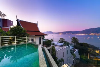 a swimming pool on a building with a view of the water at Jirana Patong in Patong Beach