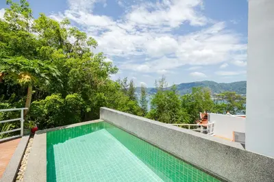 a swimming pool on the roof of a house at Jirana Patong in Patong Beach