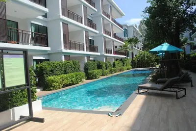 a swimming pool in front of a building at CHEZ MAURICE A RAWAIi in Rawai Beach