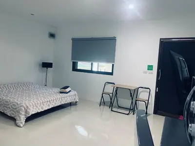 a bedroom with a bed and a table and two chairs at Гостевой домик in Ban Saiyuan (1)