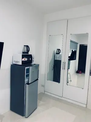 a kitchen with a refrigerator and a mirror at Гостевой домик in Ban Saiyuan (1)