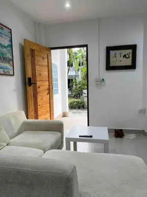 a living room with a couch and a table at Charming Villa Suite with Cozy Terrace near Beach in Patong Beach