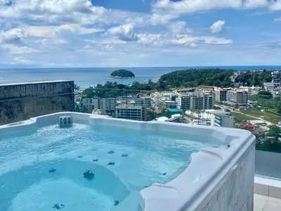 a hot tub on top of a building with a view of the ocean at The View Condominium 360 m2 Sea View Penthouse in Kata Beach