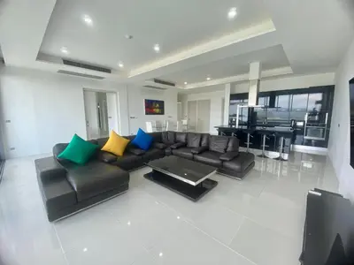 a living room with a black couch and a table at The View Condominium 360 m2 Sea View Penthouse in Kata Beach