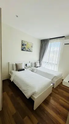 a hotel room with two beds and a window at Title Halo, 2 bedrooms apartment in Nai Yang Beach