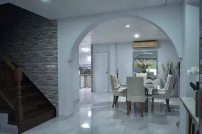 a dining room with a table and chairs and a staircase at MODERN 3BR Katabeach sweet Home in Kata Beach