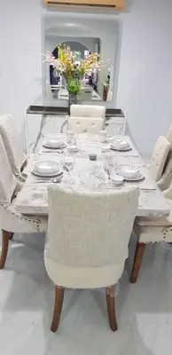 a dining table with plates and glasses on it at MODERN 3BR Katabeach sweet Home in Kata Beach
