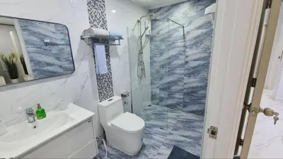 a bathroom with a shower and a toilet and a sink at MODERN 3BR Katabeach sweet Home in Kata Beach