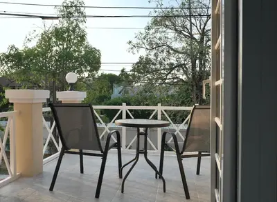 a patio with two chairs and a table on a balcony at MODERN 3BR Katabeach sweet Home in Kata Beach