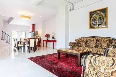 a living room with a couch and a table at Home in Phuket in Ban Phlu Yai