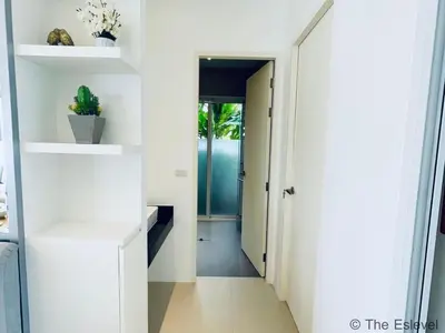 a hallway of a house with white walls and white shelves at Anchan House KML Welcome in Kamala Beach