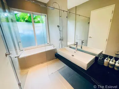 a bathroom with a sink and a shower and a mirror at Anchan House KML Welcome in Kamala Beach
