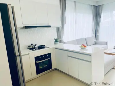 a small kitchen with white cabinets and an oven at Anchan House KML Welcome in Kamala Beach