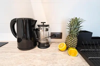 a blender and a pineapple on a kitchen counter at Paradise Bird in Nai Yang Beach