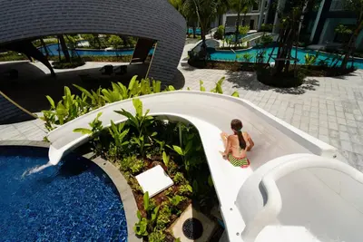 a woman sitting in a bath tub in a pool at Paradise Bird in Nai Yang Beach