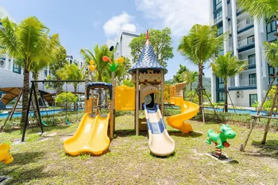 a playground at a resort with slides and play equipment at Paradise Bird in Nai Yang Beach
