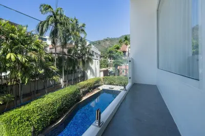 a view from the balcony of a house with a swimming pool at Sunnyside Kata in Kata Beach