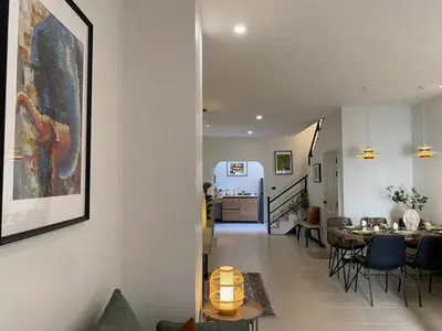 a living room with a table and a dining room at Sea Breeze Villa Patong in Patong Beach