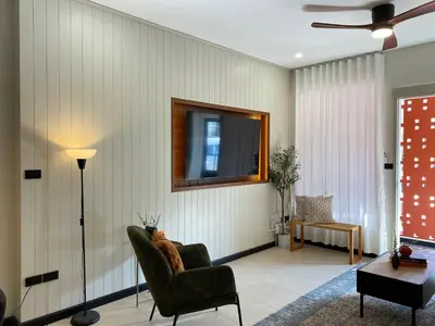 a living room with a couch and a chair at Sea Breeze Villa Patong in Patong Beach