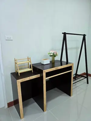 a desk with a chair and flowers on top of it at Aonang Riverside Home in Ban Khlong Son