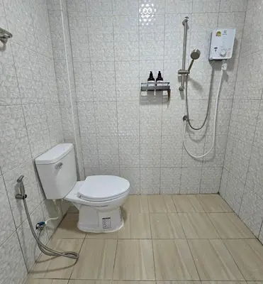a bathroom with a toilet and a shower at Aonang Riverside Home in Ban Khlong Son