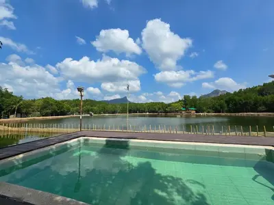 a swimming pool with a large body of water at Aonang Riverside Home in Ban Khlong Son