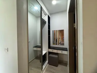 a bathroom with a large mirror and a television at Royal Lee Condo in Ban Bo Han